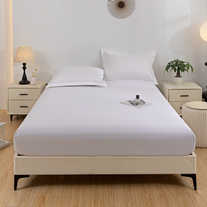 Bed with white bedding in a bedroom setting with nightstands and decor.
