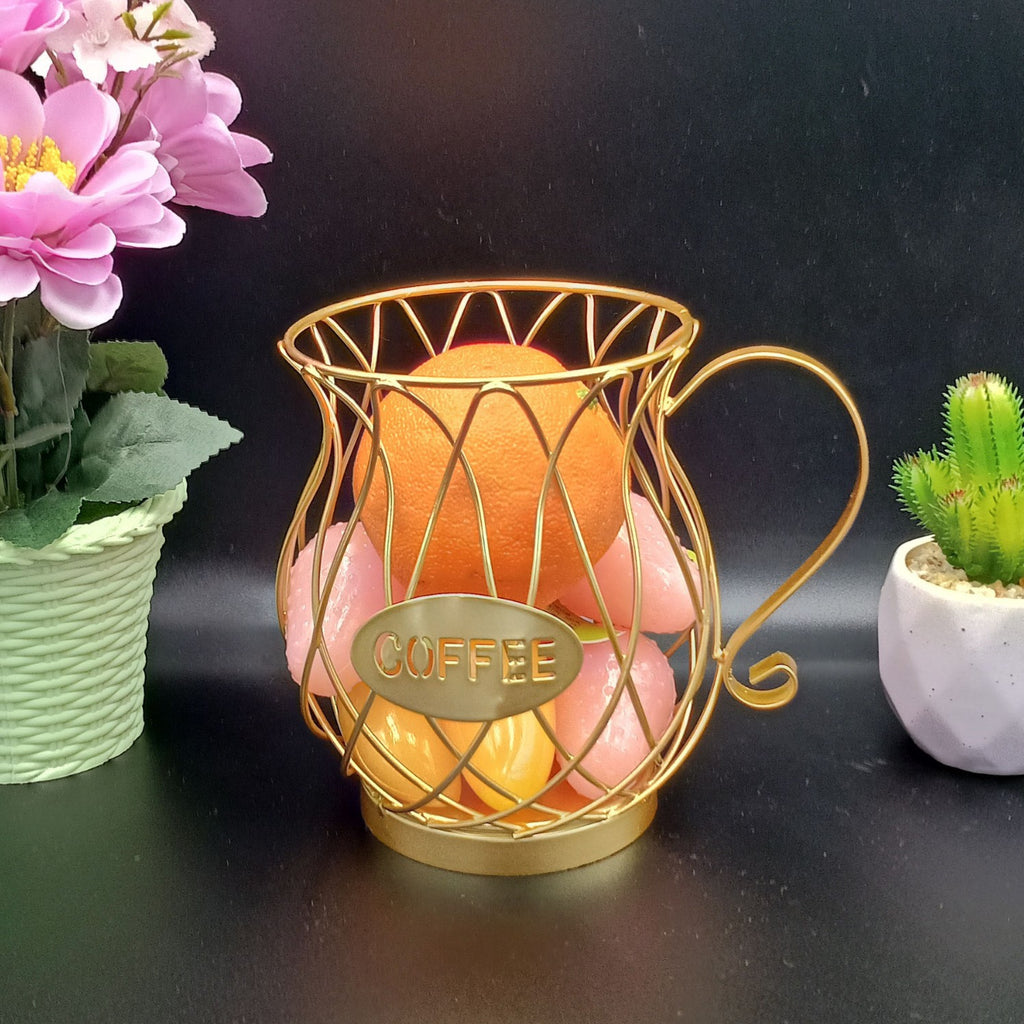 Decorative gold coffee capsules holder with pink flowers and a cactus on a dark background