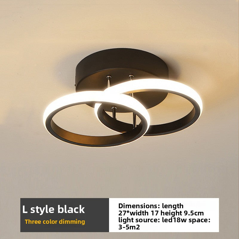 Modern ceiling light fixture with circular design on a neutral background