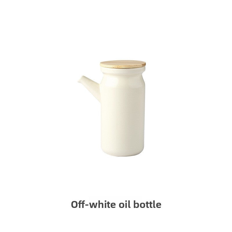 Off-white oil bottle with a wooden cap on a white background