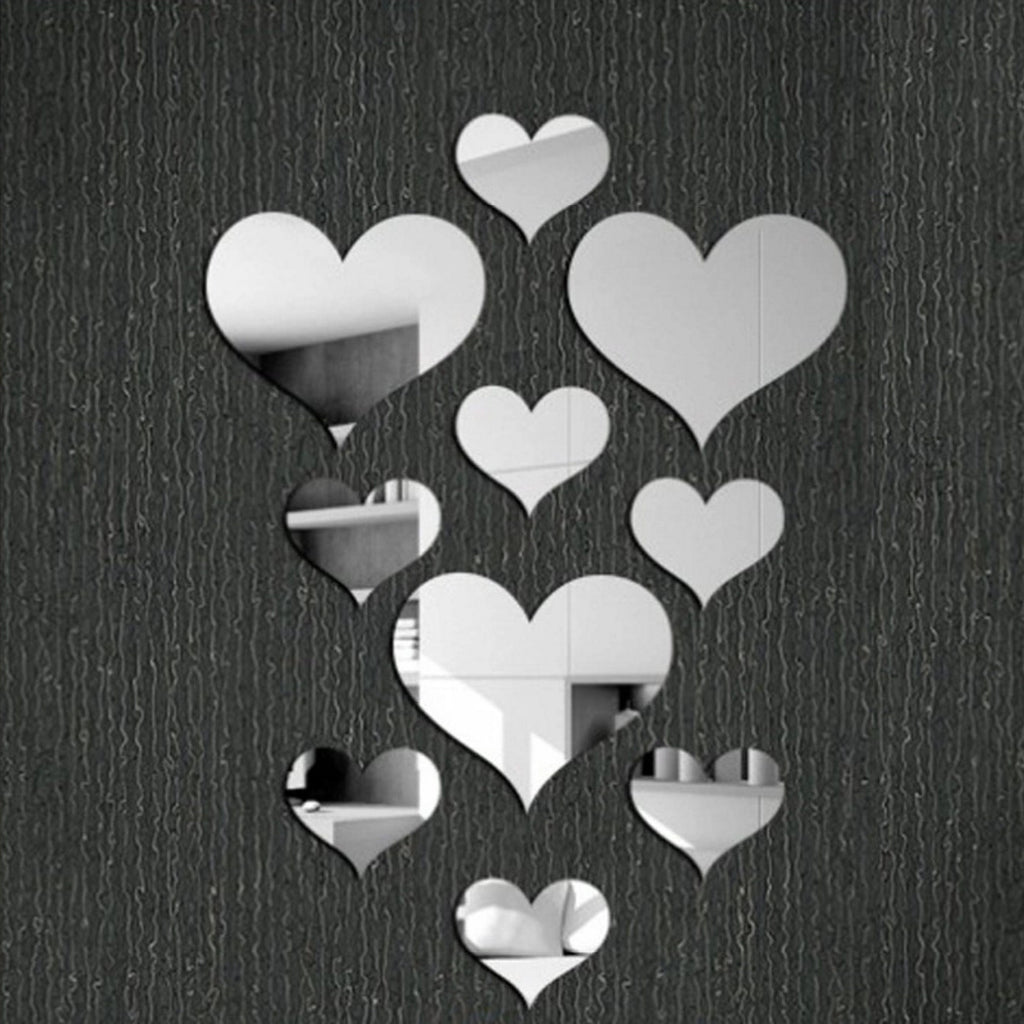 Heart-shaped mirror stickers on a textured black wall