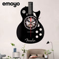 Guitar-shaped wall clock with 'Fender' branding in a living room setting.