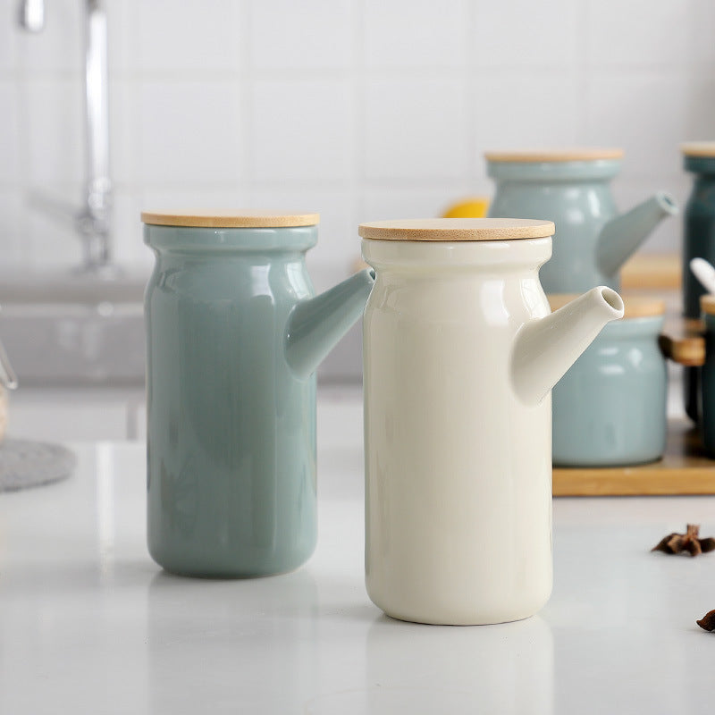 Two ceramic pots with wooden lids on a kitchen counter.