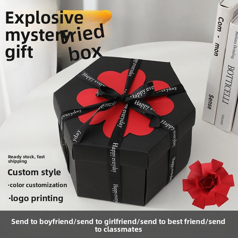Black gift box with red bow and flower on a white surface, with promotional text overlay.