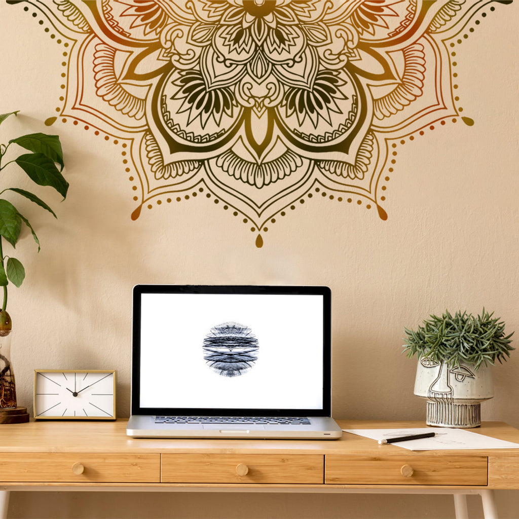Decorative mandala wall decal on a beige wall with a laptop on a wooden desk.