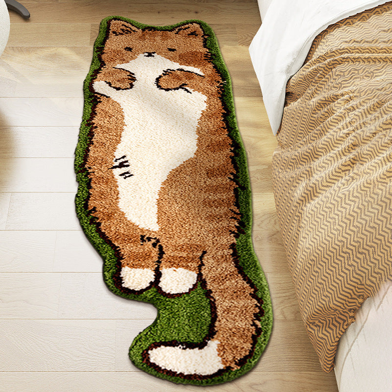 Cat-shaped rug on a wooden floor next to a bed