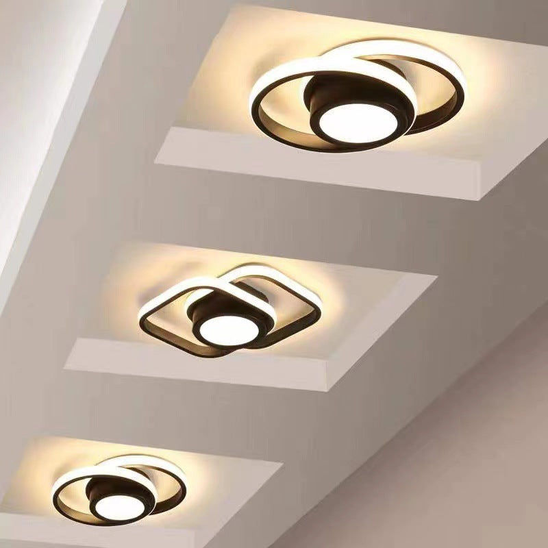 Three modern ceiling lights mounted on a ceiling