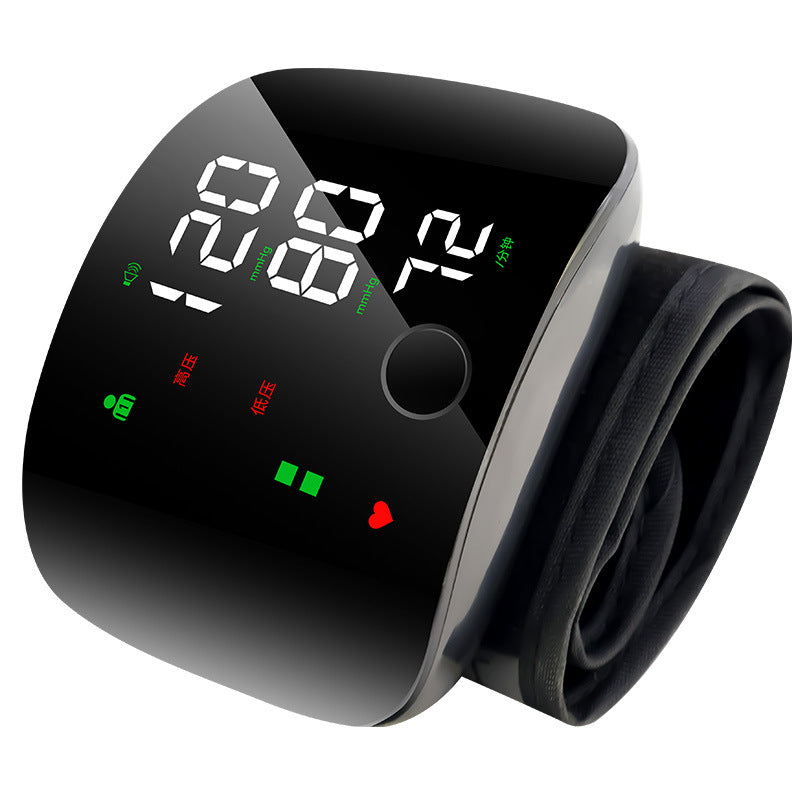 Digital blood pressure monitor with a black display and arm cuff on a white background