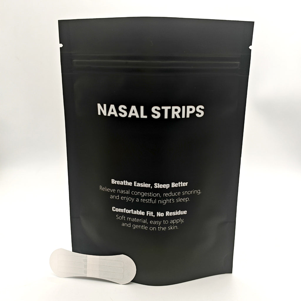 Black package of nasal strips with a white strip on a light gray background