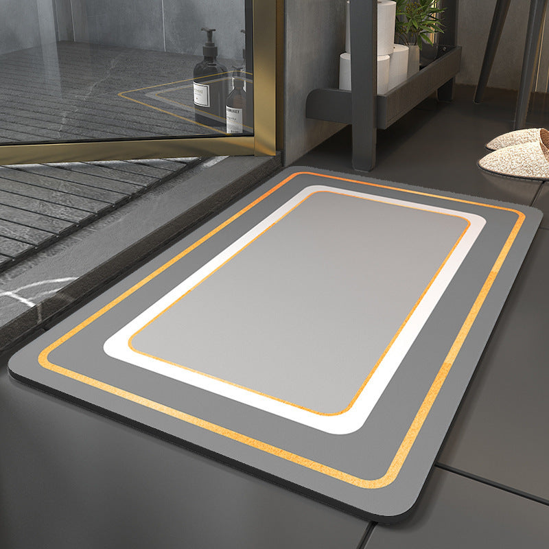 Gray mat with orange border on a bathroom floor