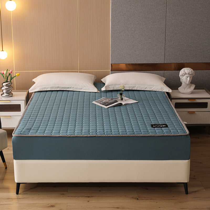 Blue mattress cover on a bed in a bedroom setting