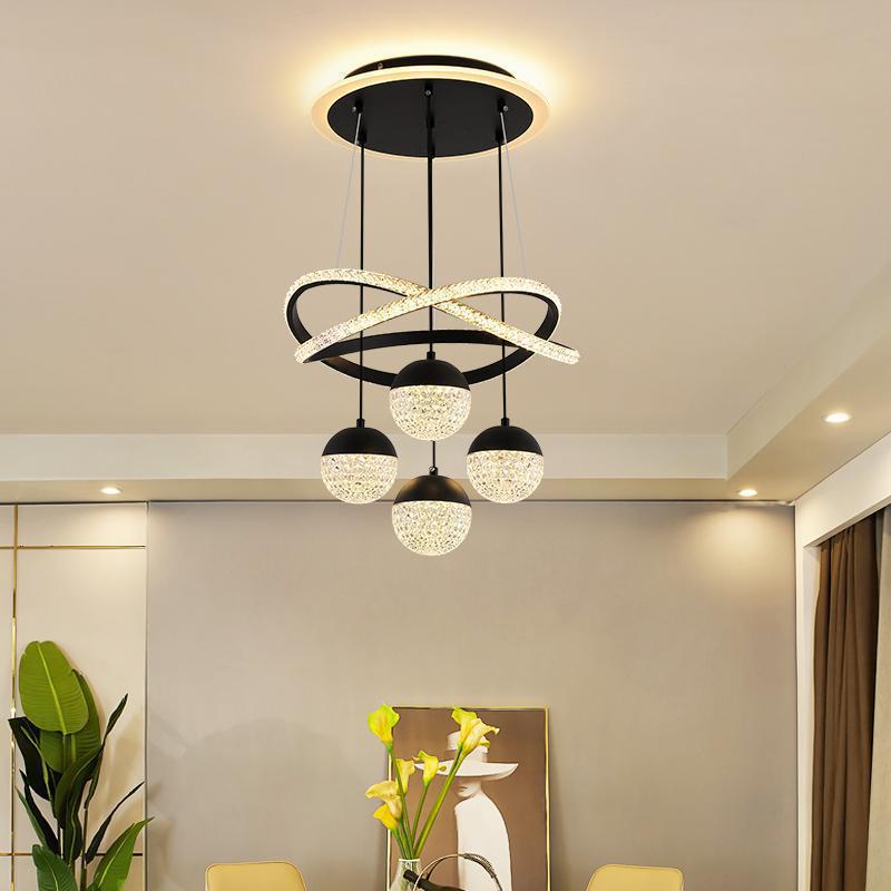 Modern chandelier hanging in a room with decor elements.