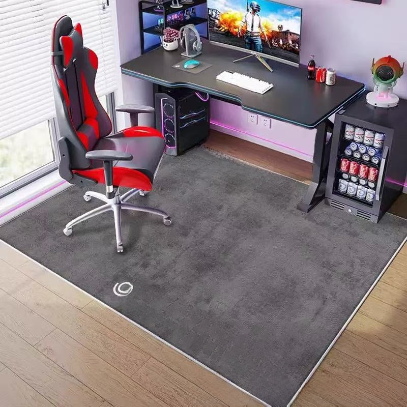 Modern gaming setup with a desk, chair, and computer equipment in a room.