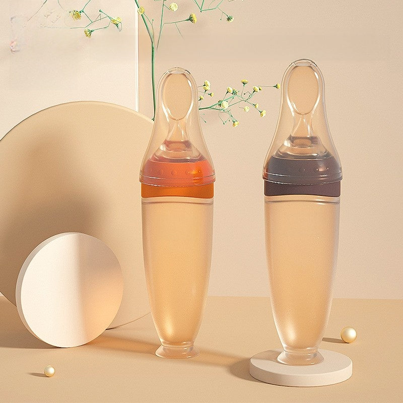 Two glass bottles with a liquid inside on a beige background