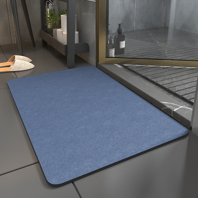 Blue mat on a tiled floor with a glass door in the background