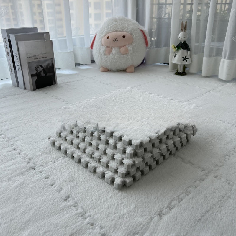 Folded rug on a white carpet with plush toys in the background