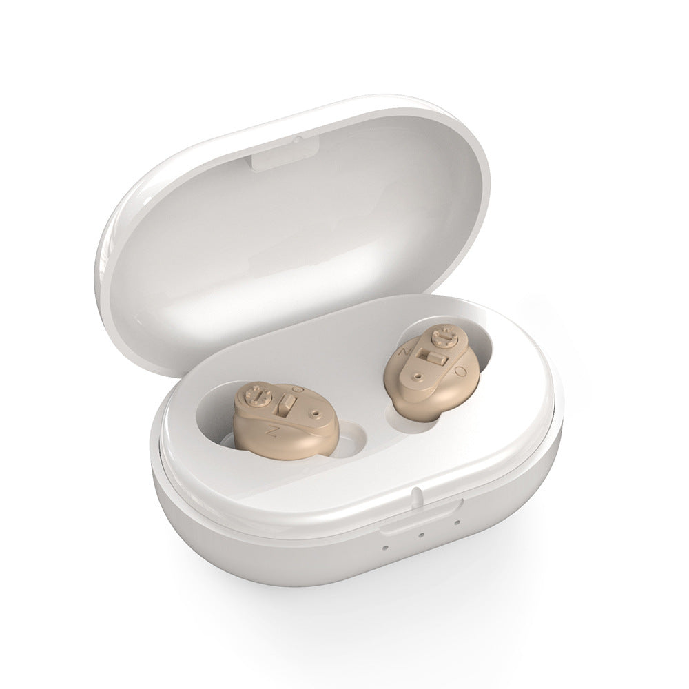 Beige hearing aids in a white charging case on a white background