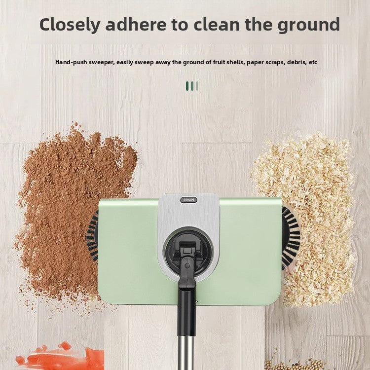 Hand-push sweeper cleaning fruit shells, paper scraps, and debris on a wooden surface.