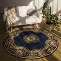 Decorative round rug with intricate patterns in a room with a white chair and plants.