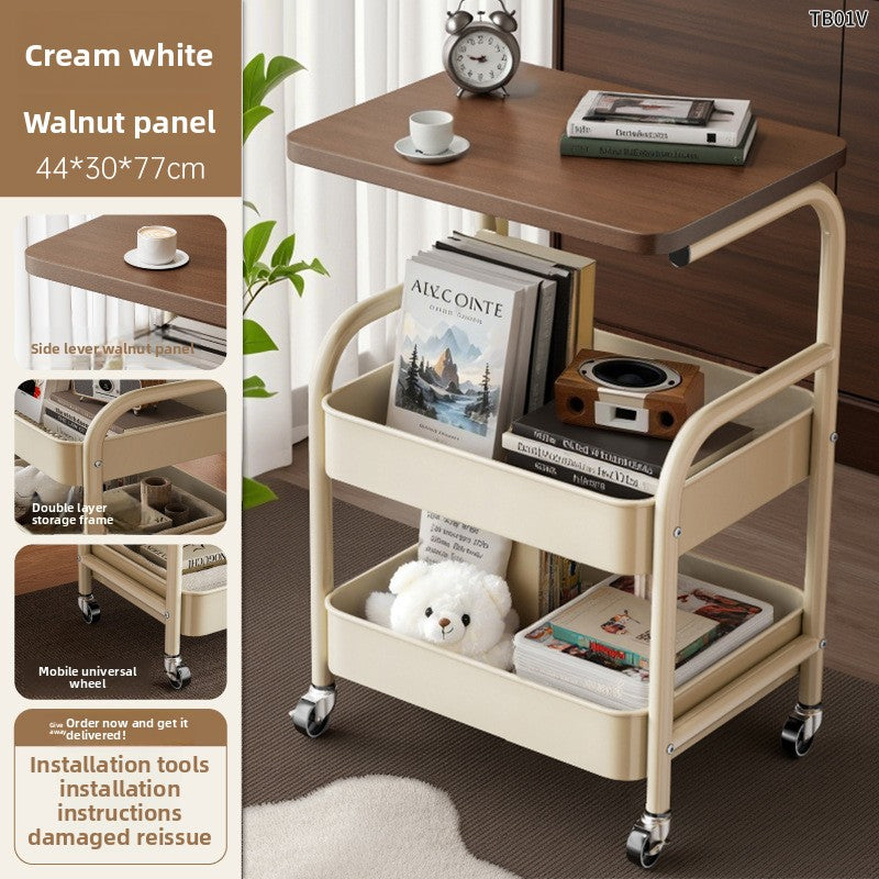 Multifunctional trolley with wooden top and cream base, featuring books and a teddy bear.