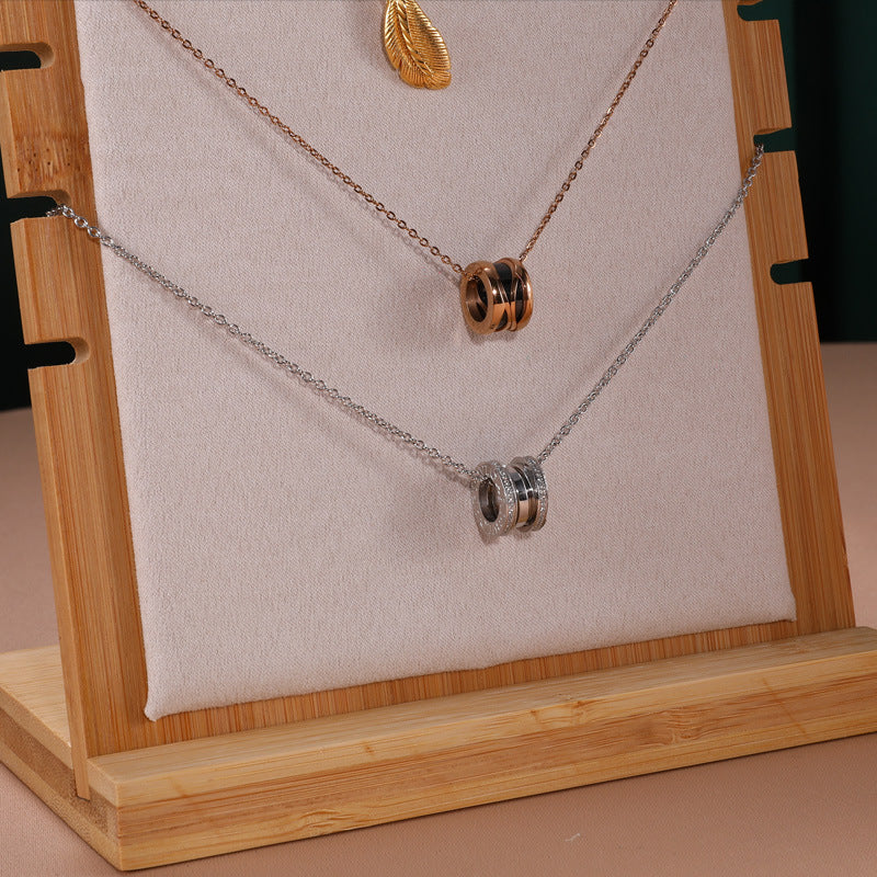 Necklace with circular pendants on a wooden stand