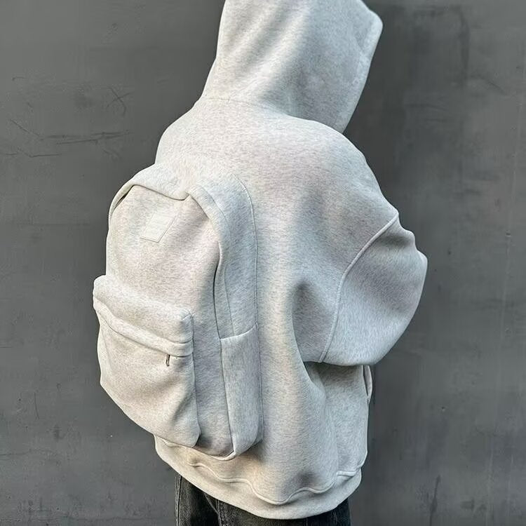 Gray hoodie worn by a person against a gray background