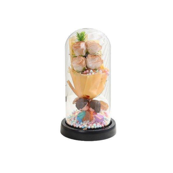 Decorative item with flowers and a sand timer inside a glass dome on a white background