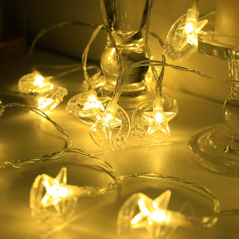 String lights with star-shaped bulbs on a reflective surface