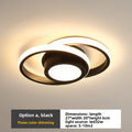 Modern ceiling light fixture with black and white design on a neutral background