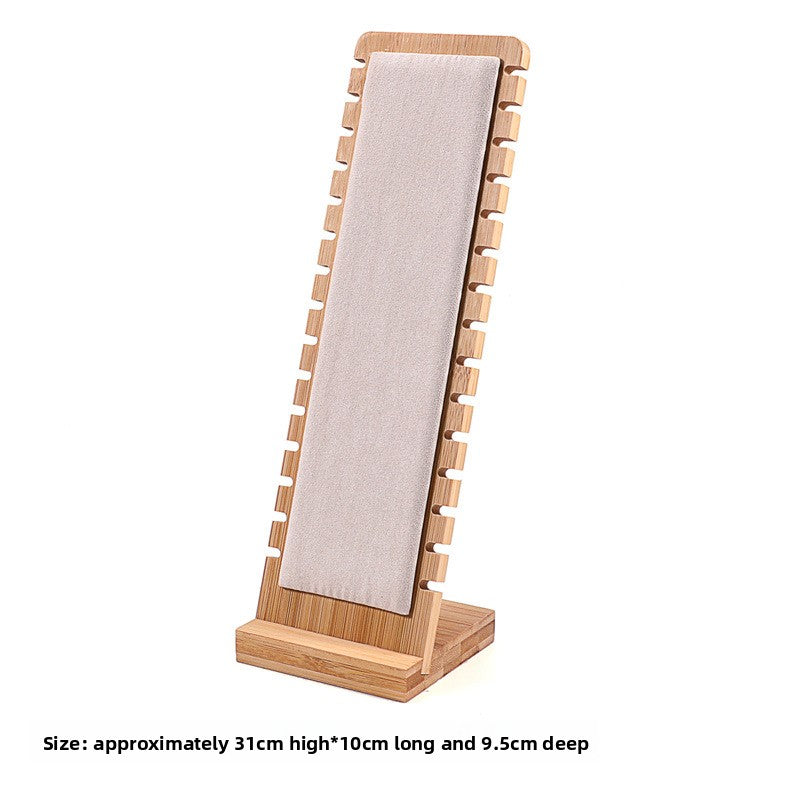 Wooden jewelry display stand with a mirror on a white background