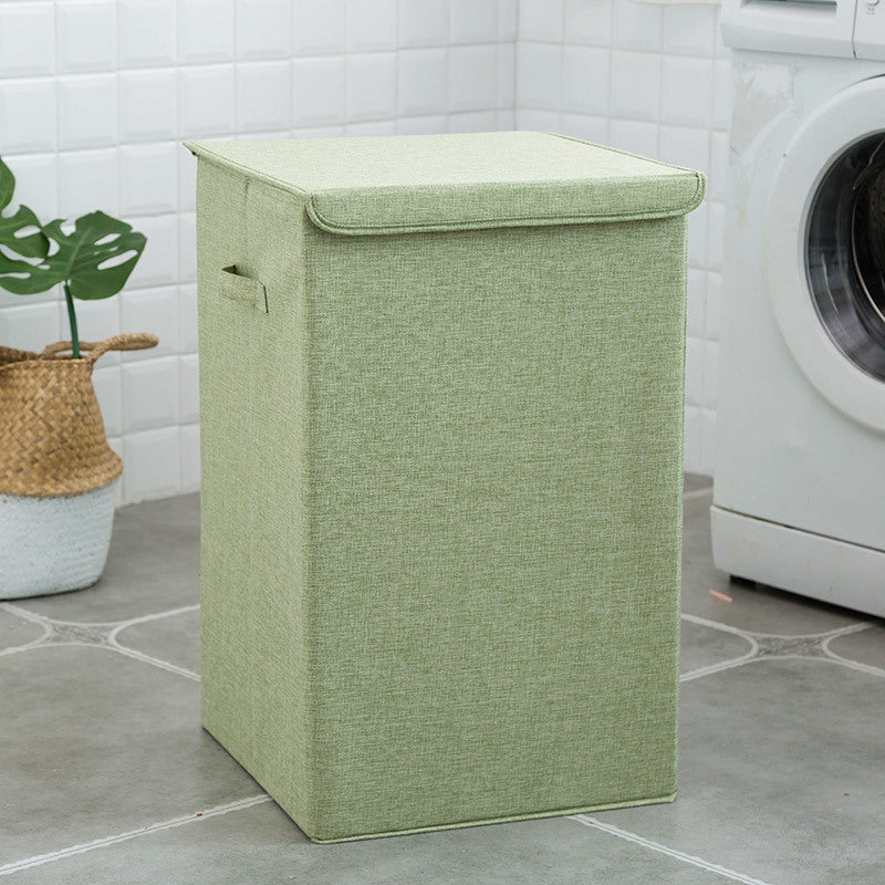 Green laundry basket in a bathroom with a washing machine in the background