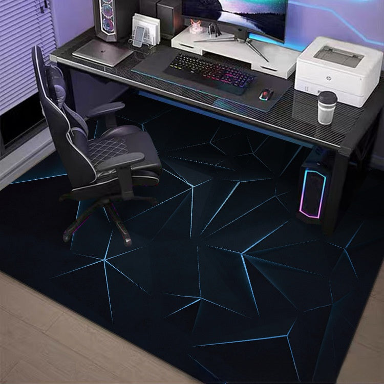 Gaming desk setup with chair, computer equipment, and a dark rug with geometric patterns.