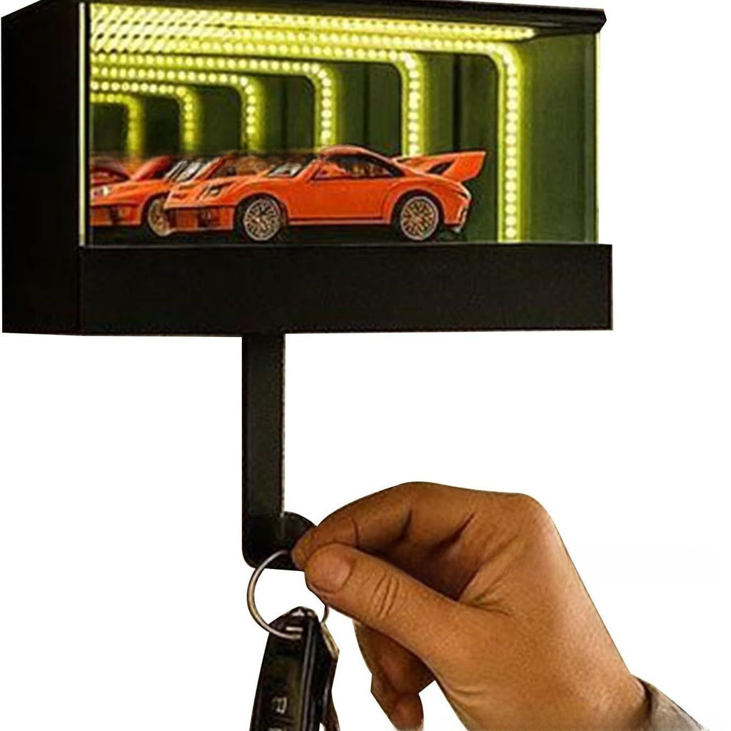Keychain with a small LED display showing an orange sports car, held by a hand.