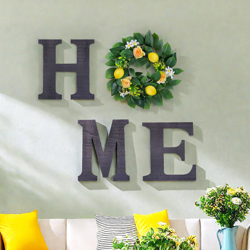 Decorative wall art with 'HOME' letters and a floral wreath on a light gray wall.