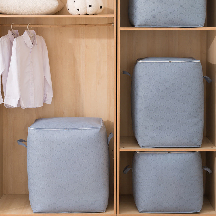 Gray laundry baskets in a wooden wardrobe with clothes on hangers