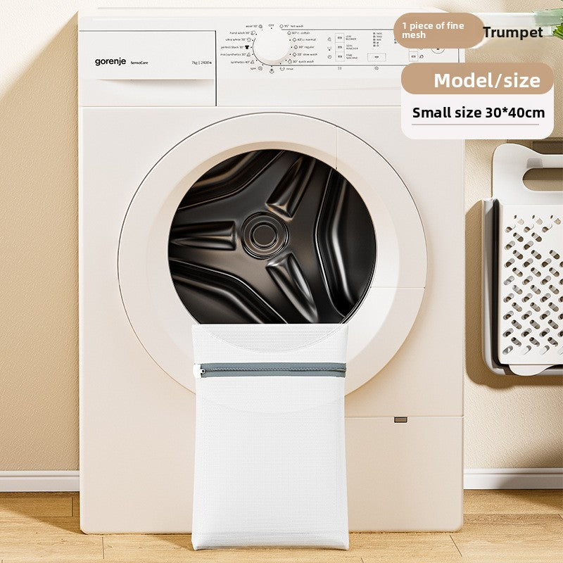 Gorenje washing machine with a black tire inside, on a beige floor.