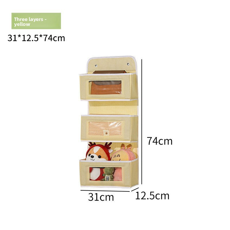 Three-layered beige wall-mounted storage organizer with dimensions and plush toys inside.