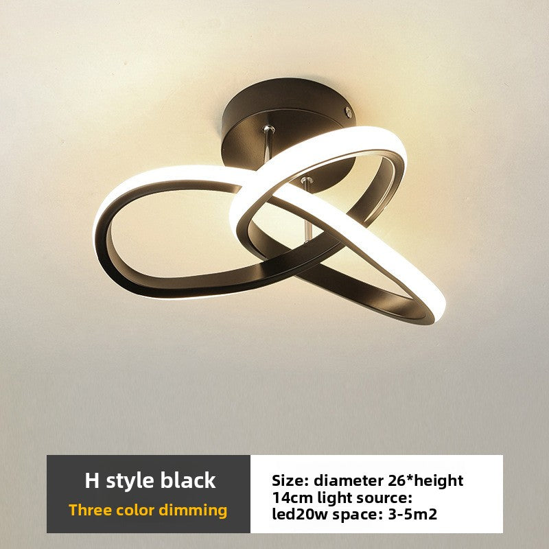 Ceiling light fixture with two interlocking rings on a neutral background