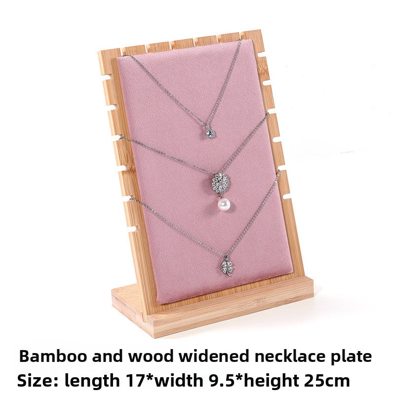 Necklace on a wooden display stand with pink fabric, size information displayed.