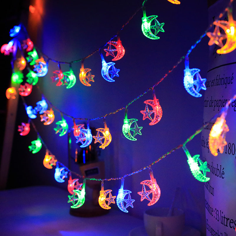 String lights with colorful moon and star designs on a dark background