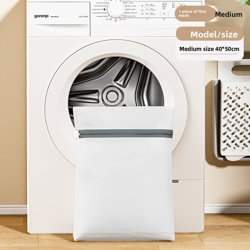 White dryer with a mesh screen in front, placed on a wooden floor.