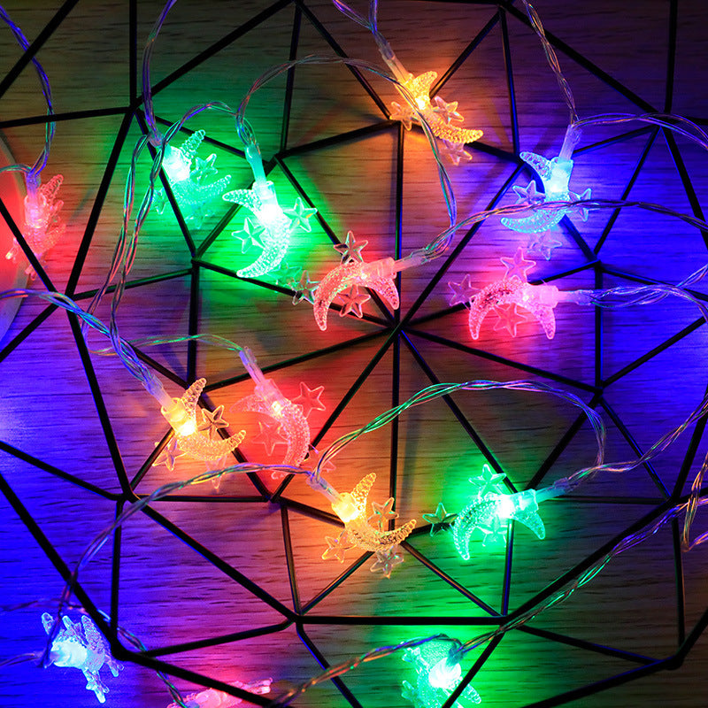 String lights with colorful butterfly-shaped bulbs on a geometric wooden background