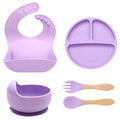 Purple baby feeding set with bib, plate, bowl, spoons, and fork on a white background