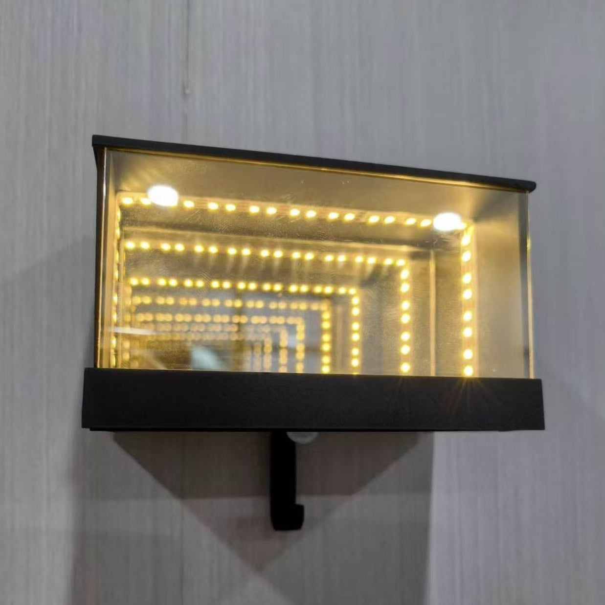 Wall-mounted light fixture with LED lights on a gray wall