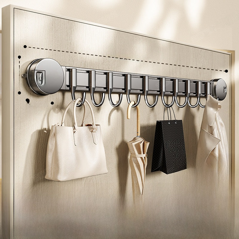 Wall-mounted hook rack with various items hanging on it against a neutral background