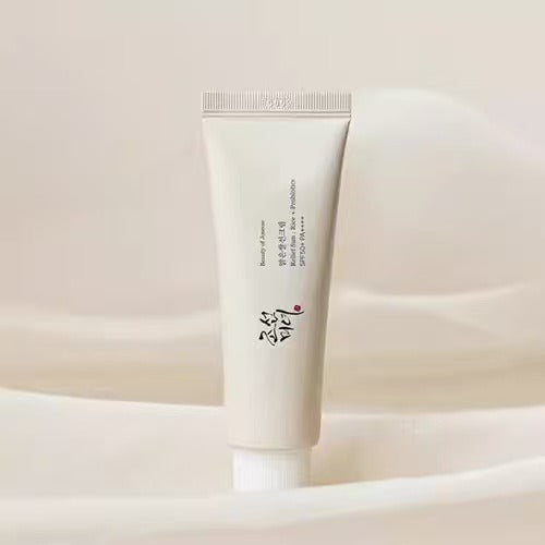 Tube of skincare product on a soft beige background