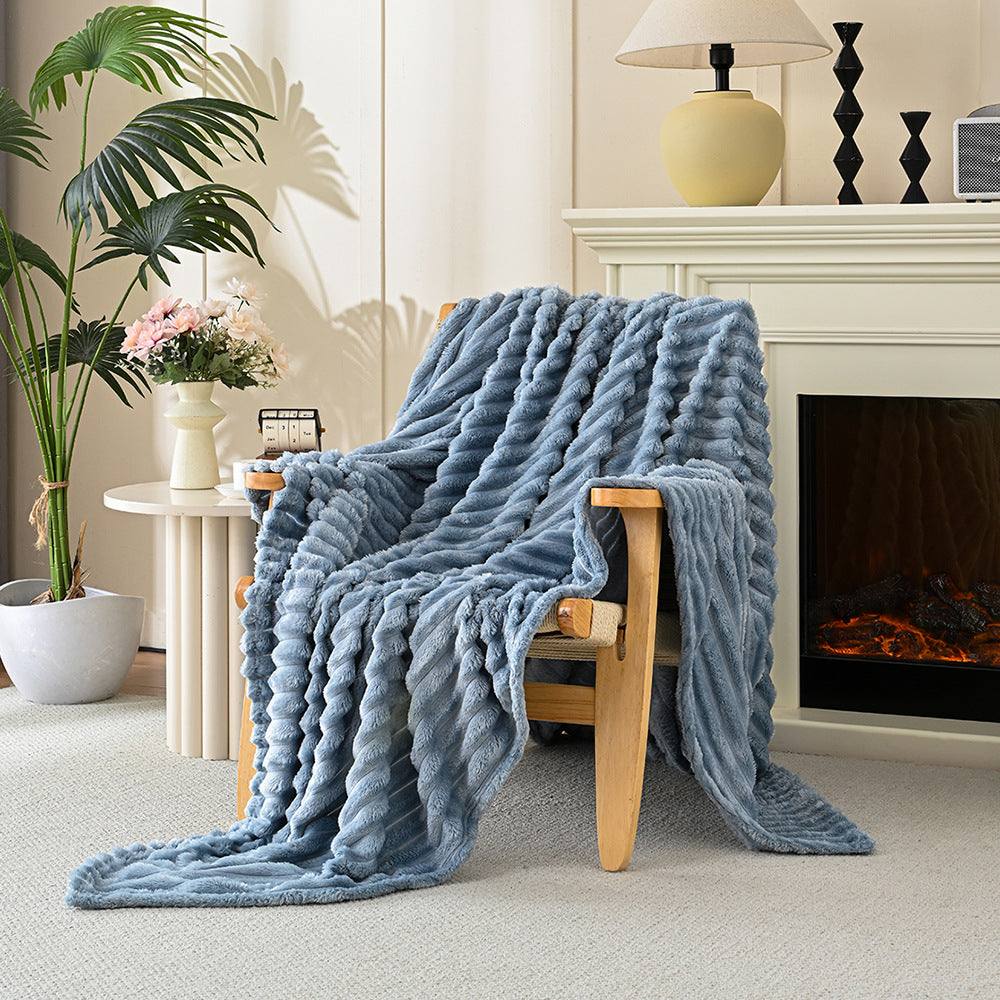 Blue blanket draped over a wooden chair in a cozy living room with a fireplace.