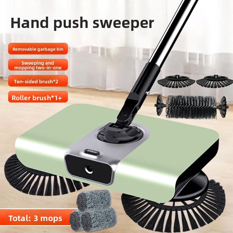 Hand push sweeper with various brushes and a removable garbage bin on a wooden floor.