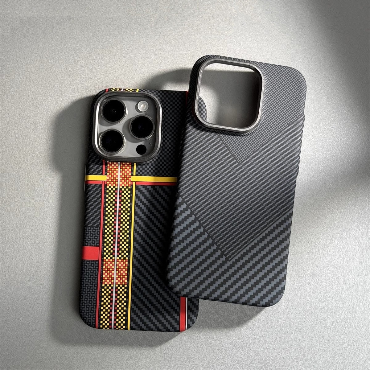 Phone case with carbon fiber texture and racing stripe design on a gray background