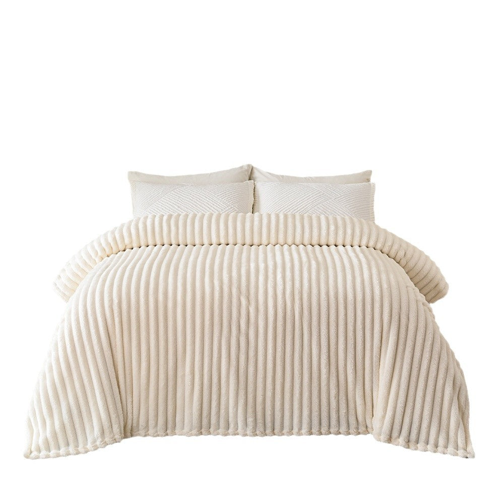 Beige textured comforter set on a bed with white pillows against a white background